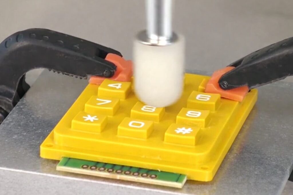 testing for yellow silicone keypad with a automatic finger tester