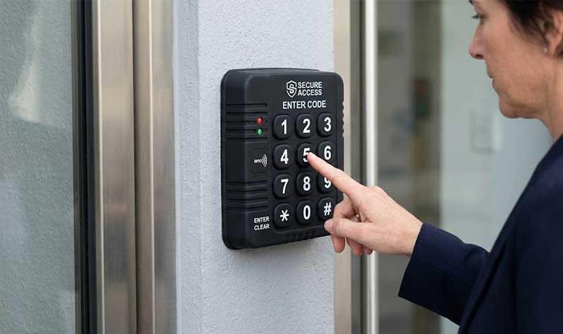 An outdoor wall mounted security access control system featuring a durable black silicone keypad with large high contrast white numbered keys