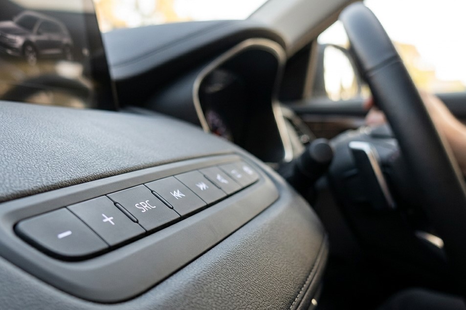 Automotive control panel with silicone keypad with exposure of UV light