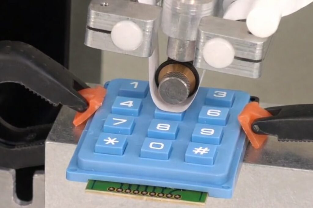 Abrasion resistance testing for a blue silicone keypad with an RCA abrasion tester