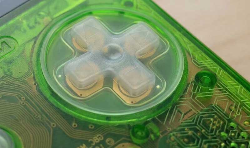 transparent green Game Boy Color Silicone Buttons showing the underlying printed circuit board and gold contacts
