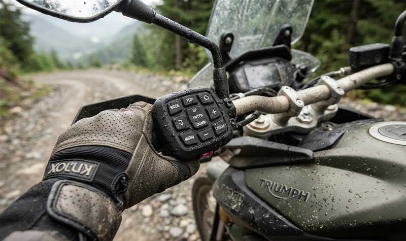 A riders hand grips a durable Motorbike Silicone Keypad on a motorcycle handlebar designed to maintain tactile response and reliable performance