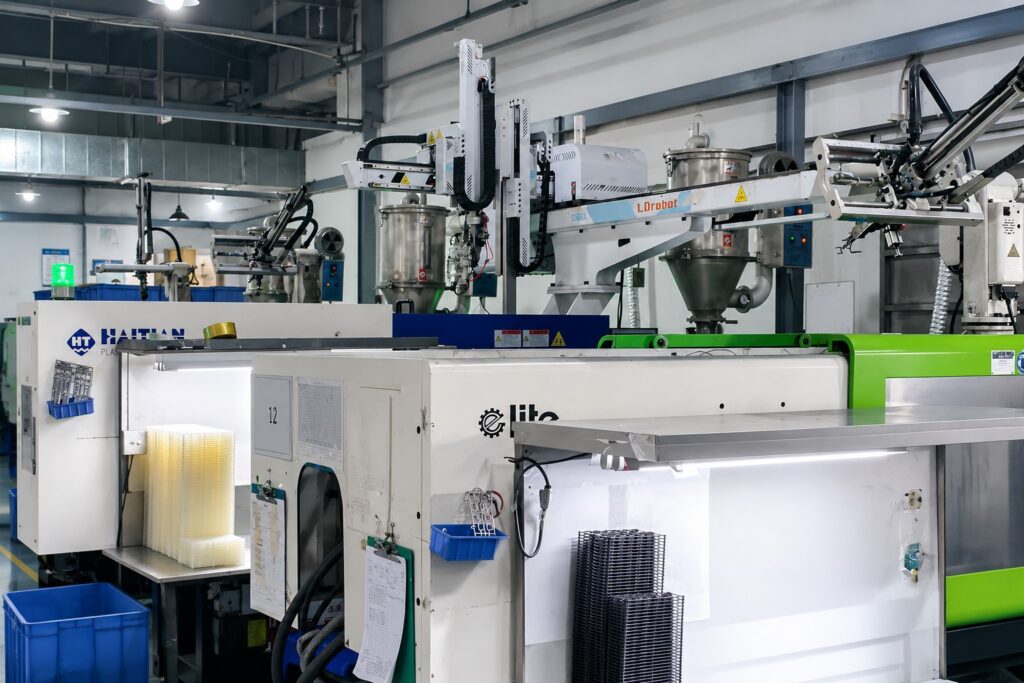 Plastic injection molding machine, dryer, loader, and robot arms for silicone rubber keypad manufacturing 