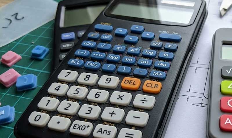 scientific calculator showcasing custom Calculator Silicone Keypads with precise key arrangements placed on a technical engineering drawing