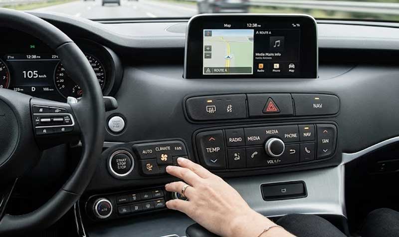 A driver uses Dustproof silicone keypads on a car center console while driving on a highway