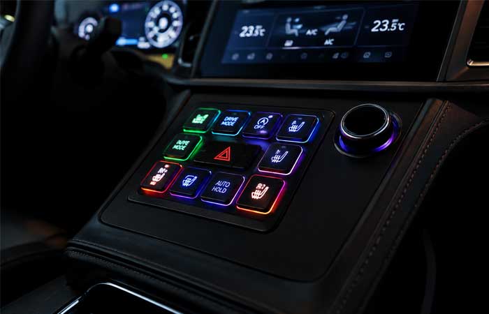 RGB silicone keypads with multi color lighting integrated into an automotive center console control panel
